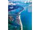 Aerial view of the coastline highlighting the island's beaches and waterways at 400 Island Way # 1606, Clearwater Beach, FL 33767