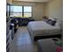 Sunlit bedroom with a large window offering scenic city views at 400 Island Way # 1606, Clearwater Beach, FL 33767