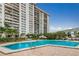 Large community pool with surrounding lounge area and tropical landscaping at 400 Island Way # 1606, Clearwater Beach, FL 33767