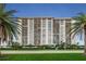 Spacious condo building featuring private balconies, lush landscaping, and convenient parking at 400 Island Way # 1606, Clearwater Beach, FL 33767