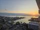 Sunrise view from the condo featuring a calm body of water, neighborhood, and clear skies at 400 Island Way # 1606, Clearwater Beach, FL 33767