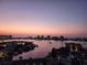 Sunset view of the water and city skyline from the condo featuring boats and buildings at 400 Island Way # 1606, Clearwater Beach, FL 33767