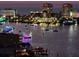 Night water view of boats decorated with lights and city buildings at 400 Island Way # 1606, Clearwater Beach, FL 33767