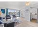 Spacious living room with waterfront views and a seamless flow to the dining and kitchen areas at 4103 Gulf Blvd # 106, St Pete Beach, FL 33706