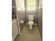 Functional bathroom featuring lavender tile, toilet, and window, with a clean and practical design at 4111 W La Salle St, Tampa, FL 33607