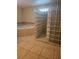 Tiled bathroom featuring a glass block shower and tiled jacuzzi tub at 4111 W La Salle St, Tampa, FL 33607