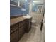 Bathroom featuring warm-toned tile accents, a vanity, and a large mirror at 4111 W La Salle St, Tampa, FL 33607