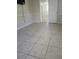 Bedroom showcasing neutral walls, tiled flooring and multiple doorways leading to different rooms at 4111 W La Salle St, Tampa, FL 33607