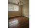 Cozy bedroom with hardwood flooring and a bright window, a simple retreat at 4111 W La Salle St, Tampa, FL 33607