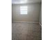 Bedroom featuring neutral walls, tiled floors, a window and electrical outlets at 4111 W La Salle St, Tampa, FL 33607