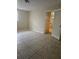 Bedroom featuring tiled floors and natural light, adjacent to an en-suite bathroom at 4111 W La Salle St, Tampa, FL 33607