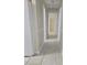 Hallway showcasing neutral walls, tiled flooring and multiple doorways leading to different rooms at 4111 W La Salle St, Tampa, FL 33607