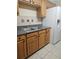 Kitchen with stainless steel sink, granite counters, wood cabinets, and white refrigerator at 4111 W La Salle St, Tampa, FL 33607