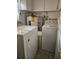 Functional laundry room with a washer, dryer, and water heater, maximizing utility space, and storage at 4111 W La Salle St, Tampa, FL 33607