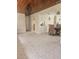 Spacious open-concept living area with tile floors, seamless transition into the dining area and wooden ceiling at 4111 W La Salle St, Tampa, FL 33607