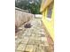 Paver patio features a wooden fence and is attached to the yellow house at 4111 W La Salle St, Tampa, FL 33607