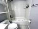 Bright bathroom featuring a tub and shower combination with white tile and a toilet at 4215 E Bay Dr # 1707C, Clearwater, FL 33764