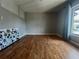 A bedroom boasting hardwood floors, freshly painted gray walls and a large window at 4215 E Bay Dr # 1707C, Clearwater, FL 33764