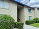Exterior view of a two-story condo building with a private entrance, tidy landscaping and neutral paint at 4215 E Bay Dr # 1707C, Clearwater, FL 33764