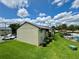 Exterior view of a two-story condo, landscaped lawn and a glimpse of the pool at 4215 E Bay Dr # 1707C, Clearwater, FL 33764
