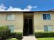 Inviting exterior featuring a quaint walkway and well-maintained landscaping leading to a two-story condo at 4215 E Bay Dr # 1707C, Clearwater, FL 33764
