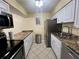 Efficient kitchen featuring updated appliances, white cabinetry, and warm countertops, ready for culinary adventures at 4215 E Bay Dr # 1707C, Clearwater, FL 33764