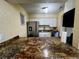 Bright kitchen featuring stone countertops and stainless steel appliances at 4215 E Bay Dr # 1707C, Clearwater, FL 33764
