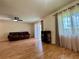 Sunlit living room featuring a comfortable sofa, sleek ceiling fan, and plenty of natural light from large windows at 4215 E Bay Dr # 1707C, Clearwater, FL 33764