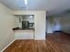 Open concept living room with wood floors adjacent to kitchen with counter at 4215 E Bay Dr # 1707C, Clearwater, FL 33764