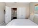 Bedroom featuring neutral walls, white bedding, and access to ensuite bathroom at 4221 W Spruce St # 1429, Tampa, FL 33607