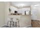 Cozy kitchen area with white cabinets, modern appliances, breakfast bar, and natural light at 4221 W Spruce St # 1429, Tampa, FL 33607