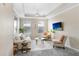 Bright living room with tray ceiling, modern furniture, large windows, and recessed lighting at 4221 W Spruce St # 1429, Tampa, FL 33607