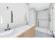 Bright bathroom featuring double sinks, a modern vanity with a marble countertop, and glass shower at 4316 Wallace Cir, Tampa, FL 33611