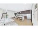 Open floor plan, white marble island, stainless steel appliances, light wood floors, and contemporary lighting at 4316 Wallace Cir, Tampa, FL 33611