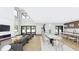 Open-concept living and dining area with modern fireplace, high ceilings, and lots of windows for natural light at 4316 Wallace Cir, Tampa, FL 33611