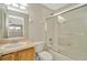 Bright bathroom features tile floor, tub and shower with glass door, and a light wood vanity at 502 Arch Ridge Loop, Seffner, FL 33584