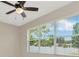 Bedroom with a ceiling fan and a window overlooking a neighborhood at 502 Arch Ridge Loop, Seffner, FL 33584