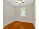 A simple bedroom with hardwood floors and a window for natural light at 502 Arch Ridge Loop, Seffner, FL 33584
