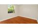 Bright, empty bedroom with hardwood floors and a large window at 502 Arch Ridge Loop, Seffner, FL 33584