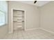 Cozy bedroom with a ceiling fan, closet shelving, and neutral walls at 502 Arch Ridge Loop, Seffner, FL 33584