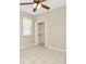 Cozy bedroom with a ceiling fan, closet shelving, and neutral walls at 502 Arch Ridge Loop, Seffner, FL 33584