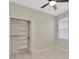 Bedroom featuring a closet, window, and tile flooring at 502 Arch Ridge Loop, Seffner, FL 33584