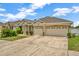 Charming single-story home with a manicured lawn, arched entryway, and three-car garage on a paved driveway at 502 Arch Ridge Loop, Seffner, FL 33584