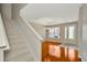 Bright foyer with staircase and hardwood floors, leading to a living room with lots of natural light at 502 Arch Ridge Loop, Seffner, FL 33584
