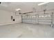 Spacious garage features three garage doors, white walls, and overhead lighting at 502 Arch Ridge Loop, Seffner, FL 33584