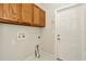 This laundry room offers white walls, a utility sink, and ample cabinet space at 502 Arch Ridge Loop, Seffner, FL 33584
