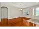 Spacious living room with hardwood floors, archways, and ample natural light at 502 Arch Ridge Loop, Seffner, FL 33584