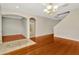 Spacious living room featuring hardwood floors and arched doorways at 502 Arch Ridge Loop, Seffner, FL 33584