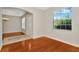 View of the living room featuring hardwood floors, arched doorways, and natural light at 502 Arch Ridge Loop, Seffner, FL 33584