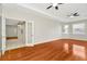 Living room featuring hardwood floors and bright, natural light flowing in from two windows at 502 Arch Ridge Loop, Seffner, FL 33584
